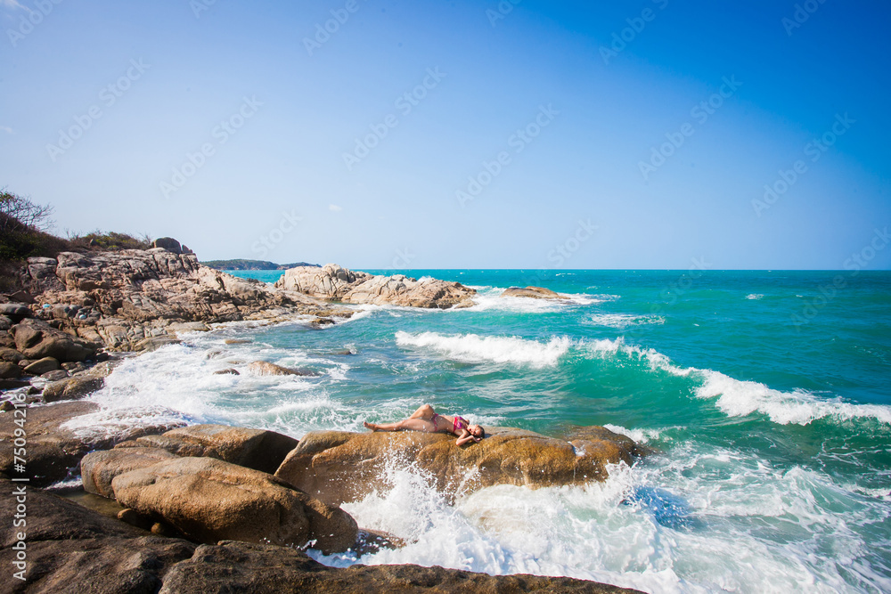 Fototapeta premium Young sexy woman in red bikini posing In front of sea on the