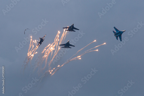 Four war jet planes in sky