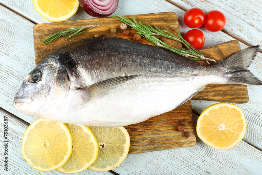 Fresh raw fish and food ingredients on table Fresh raw fish and food ingredients on table