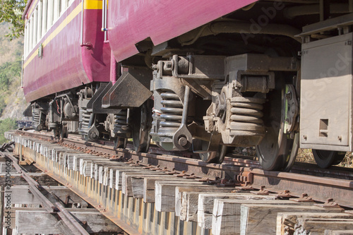 lower view of trainst suspension on old wood railways bridge