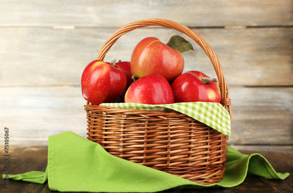 Wicker basket of red apples with green napkin Wicker basket of red apples with green napkin