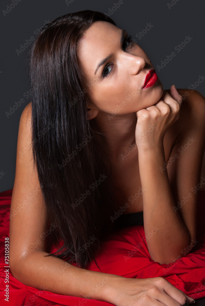 Brunnete topless with thong covered with a red fabric Brunnete topless with thong covered with a red fabric