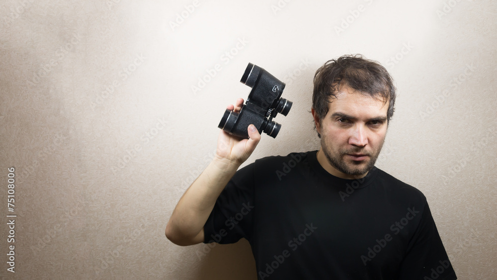 young man with binoculars young man with binoculars