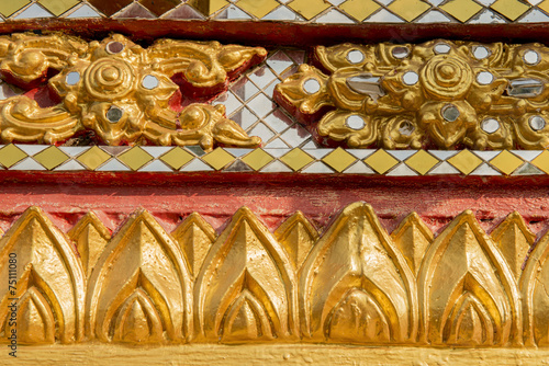 wall carving art with stained glass in the temple ,Thailand