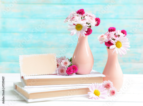Fototapeta Naklejka Na Ścianę i Meble -  Beautiful flowers in vases on table on light blue background
