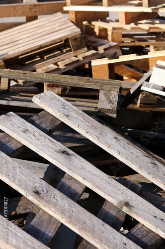pile of wooden pallets piled in a landfill