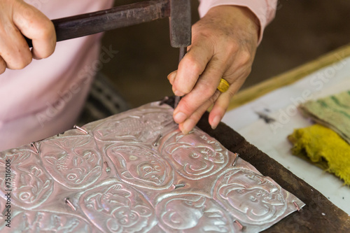 silversmith is making silverware decorating art photo
