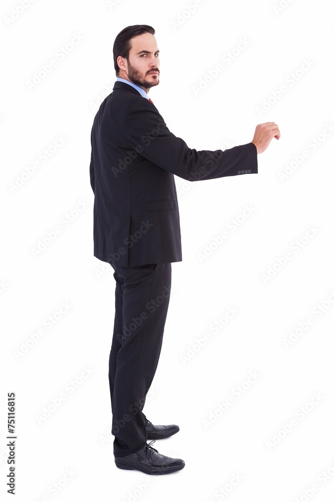 Serious businessman standing with arms raised Serious businessman standing with arms raised