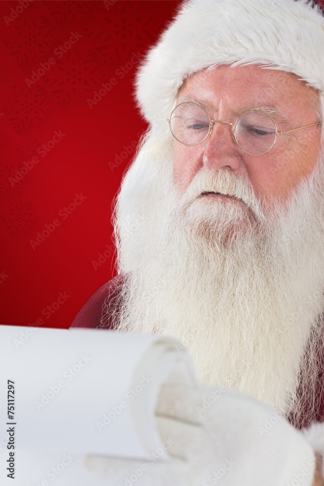 Composite image of santa claus reads a list Composite image of santa claus reads a list