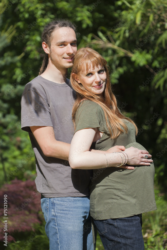 Fototapeta premium Young Couple in a park awaiting a Baby