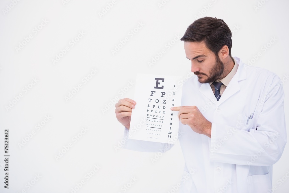 Doctor in lab coat showing eye test Doctor in lab coat showing eye test
