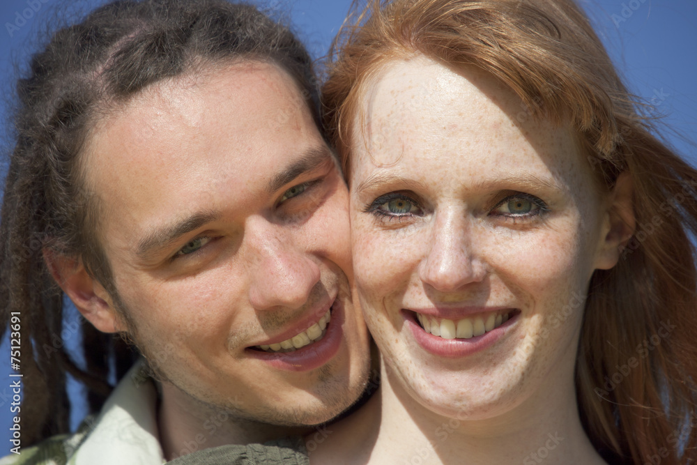 Young Couple Portrait against blue Sky Young Couple Portrait against blue Sky