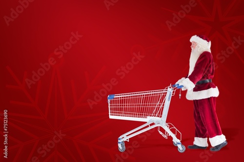 Composite image of santa pushes a shopping cart © WavebreakmediaMicro