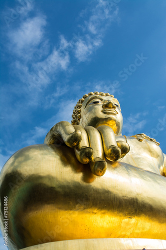 Big golden buddha statue with blue sky at Golden Triangle, Chian