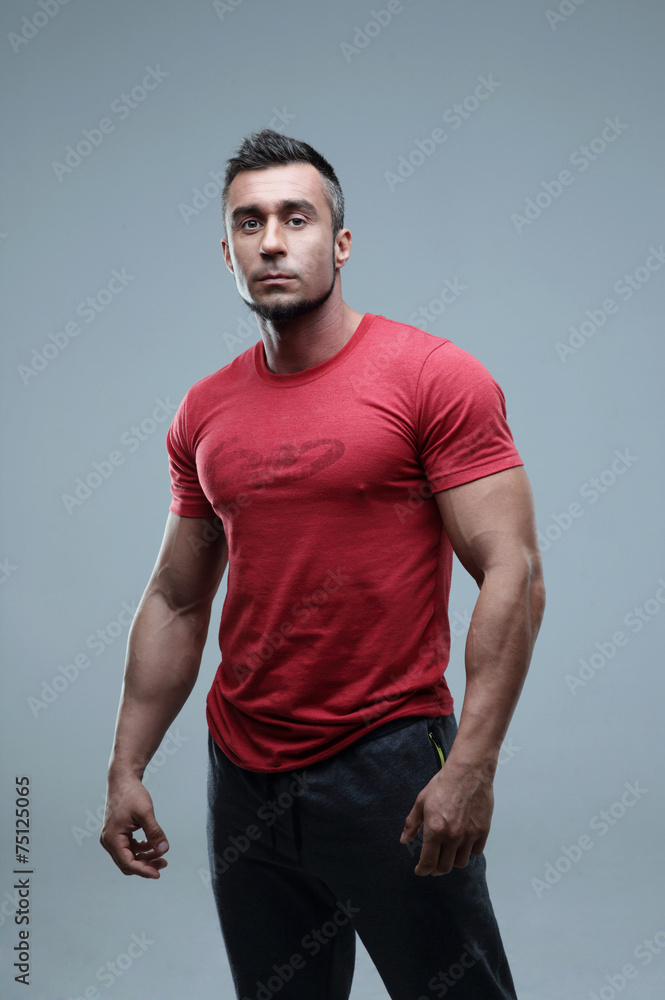 Portrait of a young serious man in red t-shirt Portrait of a young serious man in red t-shirt