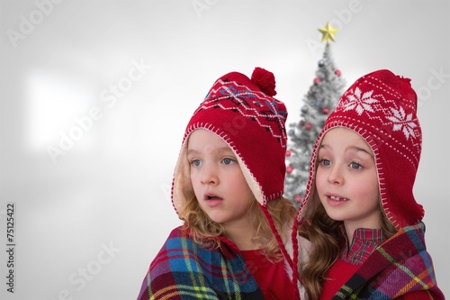 Composite image of cute girls under blanket