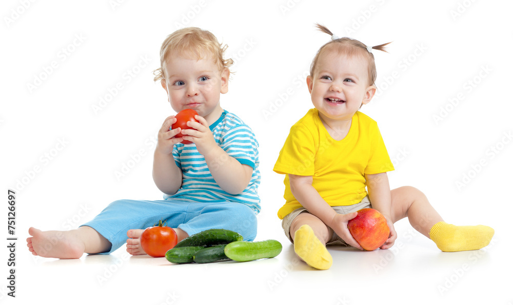 Children eating fruits and vegetables isolated Children eating fruits and vegetables isolated
