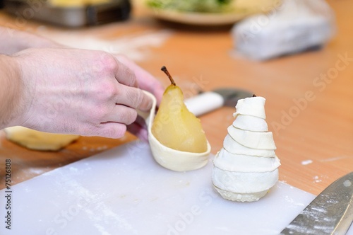 Cook prepares pear dumplings for preparation photo