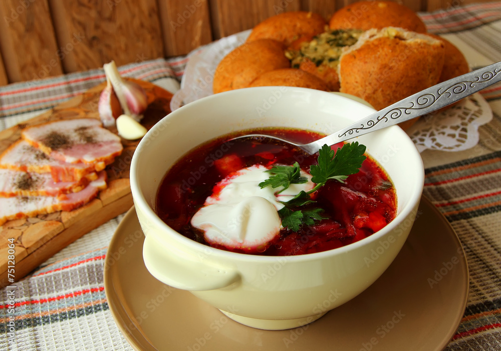A plate of hot borscht with sour cream, bread and meat. A plate of hot borscht with sour cream, bread and meat.