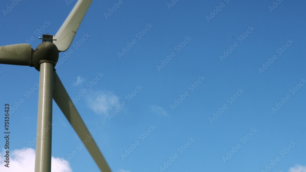 Wind energy spinning against a blue sky Wind energy spinning against a blue sky