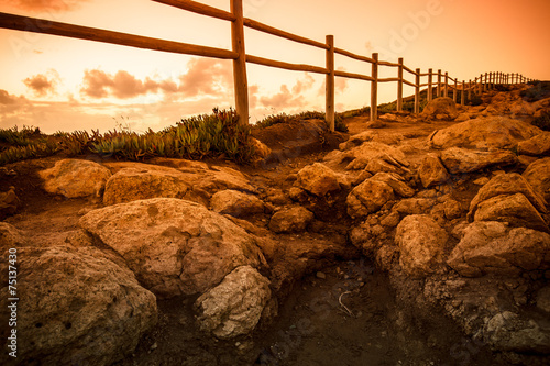 Wooden fence on the edge of Europe. Sunset. tinted photo