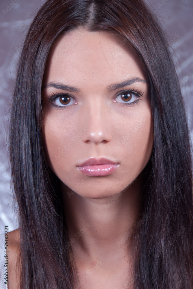 Obraz premium Young brunette woman making face expression