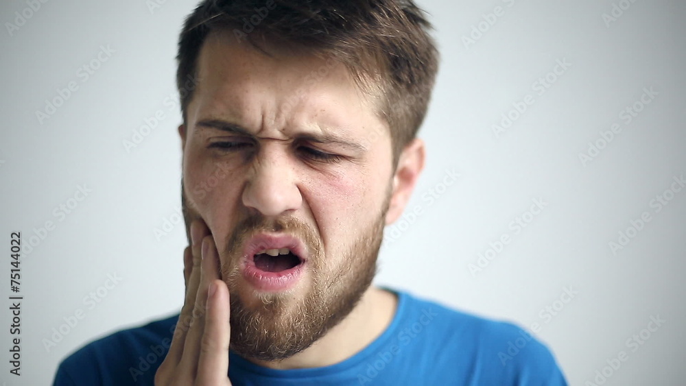 Portrait of a man experiencing toothache. Close up Portrait of a man experiencing toothache. Close up