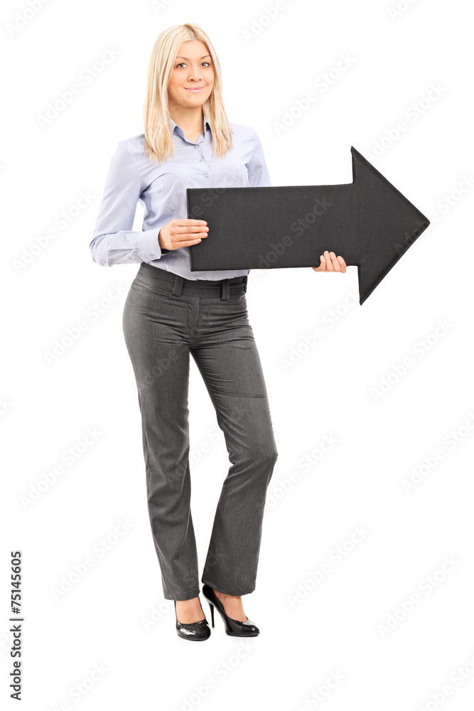 Full length portrait of a blond smiling woman holding an arrow Full length portrait of a blond smiling woman holding an arrow