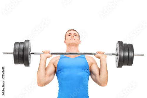 Young weightlifter training with a heavy barbell