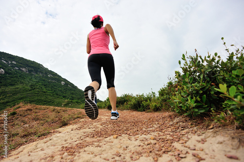  Runner athlete running on seaside mountain trail
