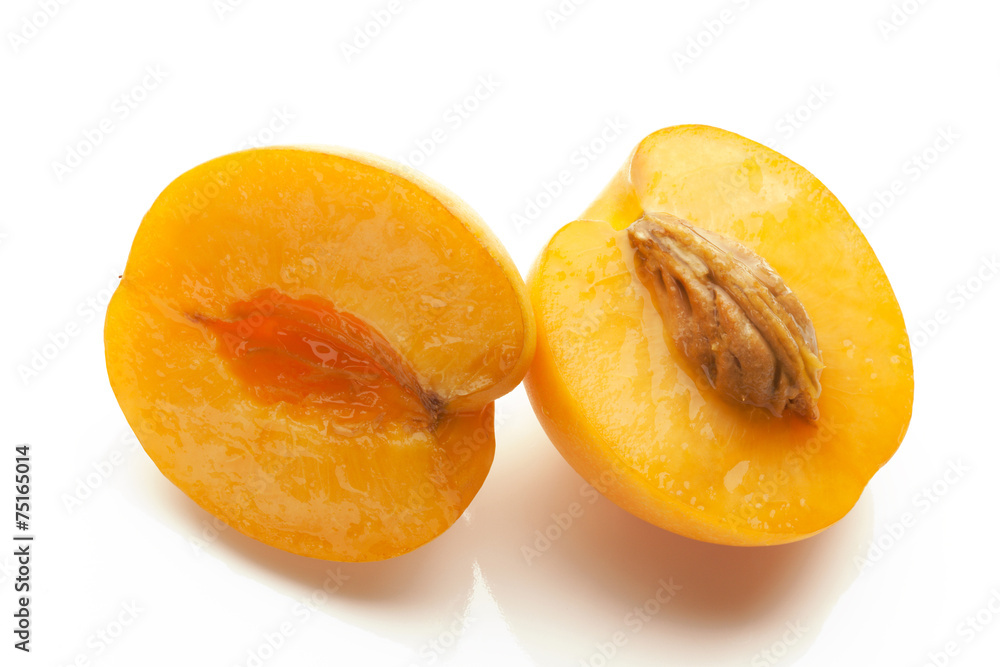 two apricots sliced isolated on white background two apricots sliced isolated on white background