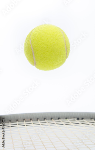 Tennis ball jumping and levitating over a raquet © alexionas