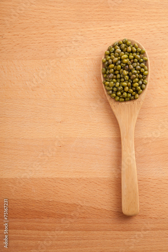 Mung beans with wooden spoon