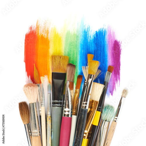 Pile of different brushes over the paint strokes