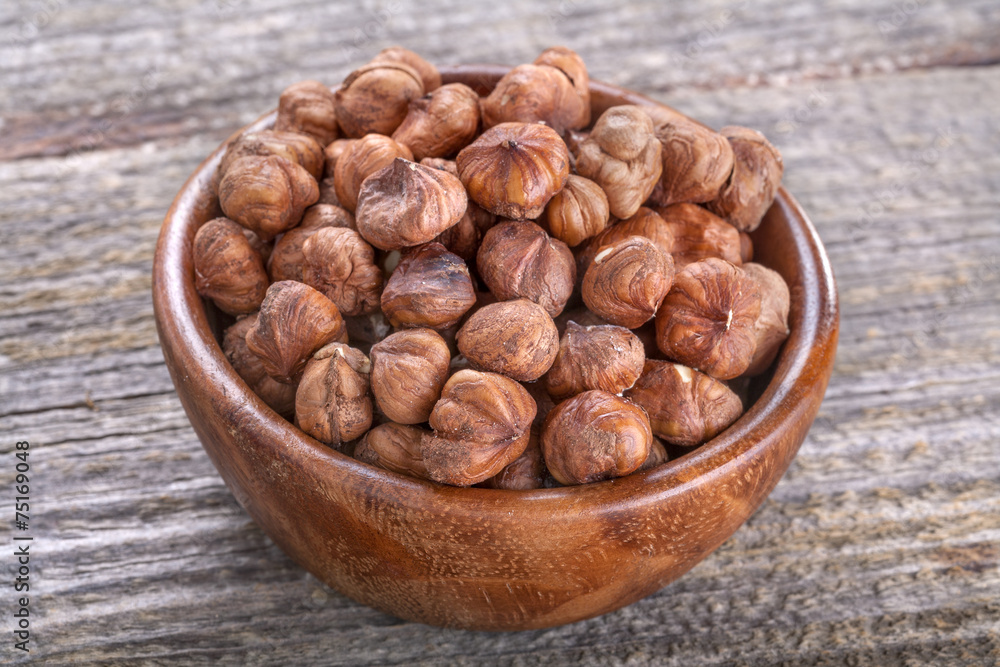 domestic hazelnuts in a wooden bowl on old rustic table domestic hazelnuts in a wooden bowl on old rustic table