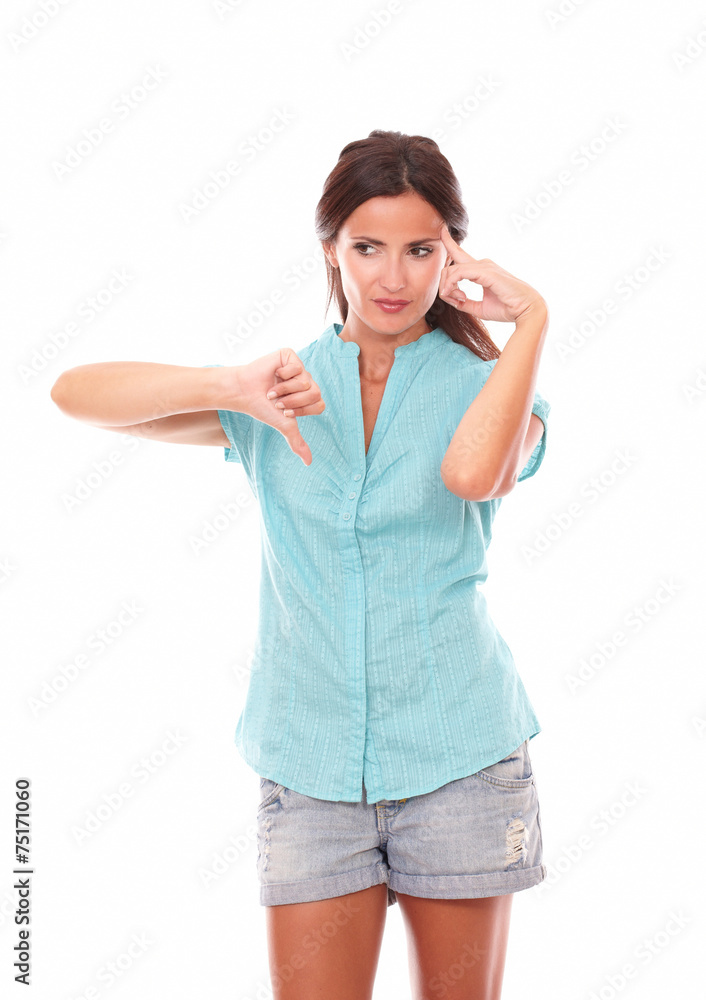 Pensive lady in short jeans with thumb down Pensive lady in short jeans with thumb down