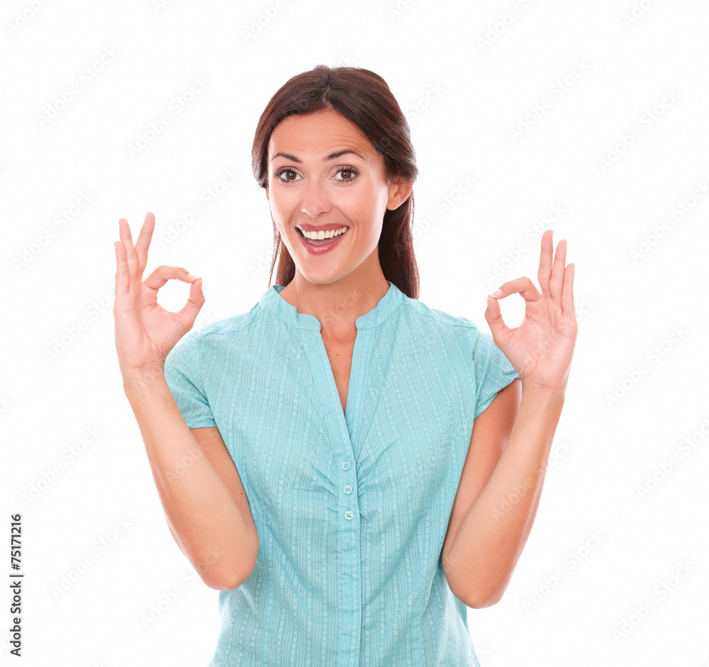 Cute brunette in blue blouse gesturing a great job Cute brunette in blue blouse gesturing a great job