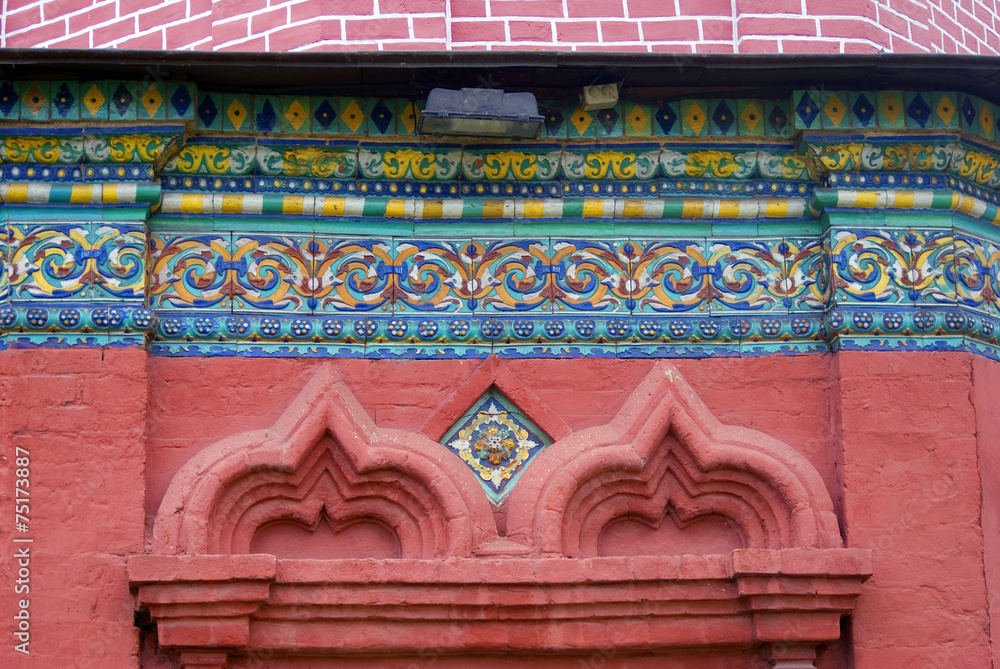Colorful tails on red bricks wall. Epiphany church, Yaroslavl.