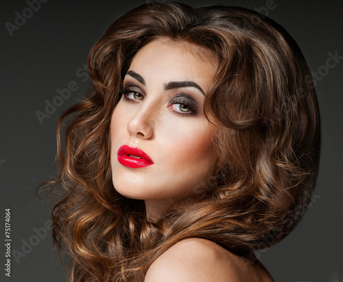 Beautiful woman with magnificent curly hair. Red lipstick.