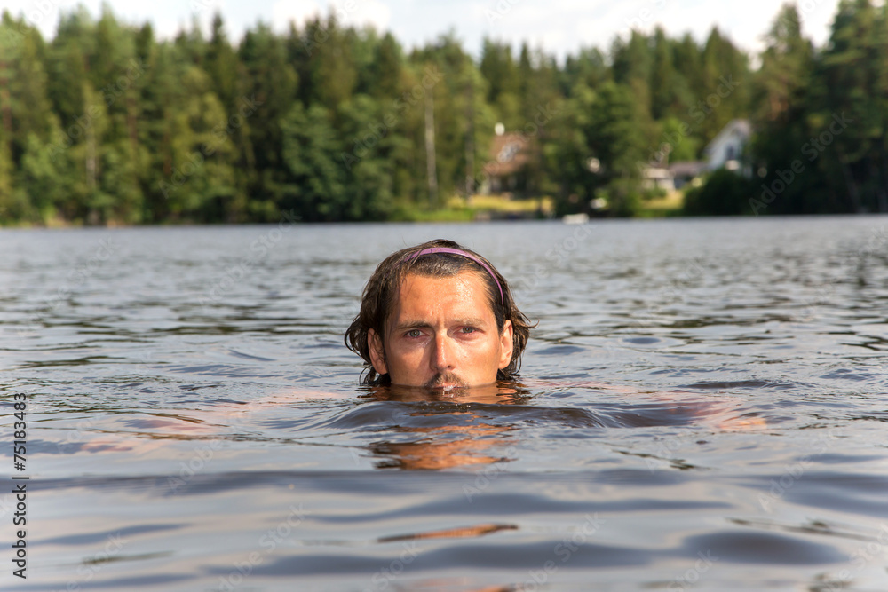 Swimming training of sportsman in lake