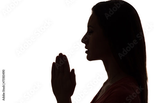 closeup profile of a woman praying in silhouette isolated