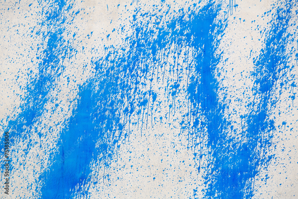 Naklejka premium Concrete wall with blue paint splatters