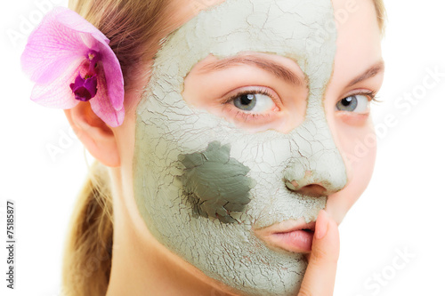 Skin care. Woman in clay mud mask on face. Beauty. photo