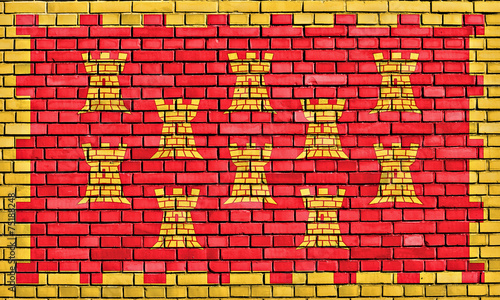 flag of Greater Manchester painted on brick wall