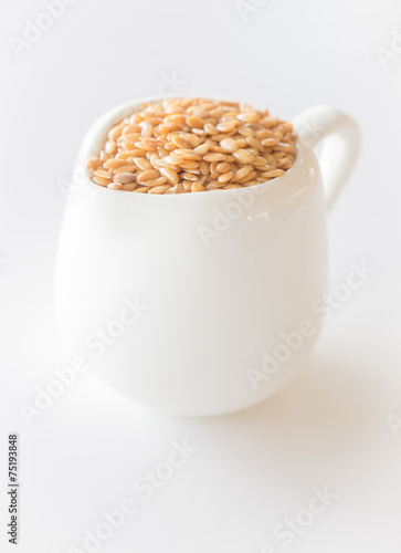 Ceramic pitcher of gold flaxseed photo