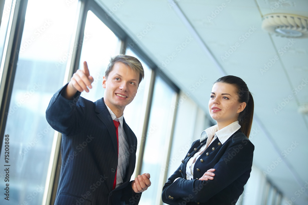 Young business woman and businessman talking in the hallway Young business woman and businessman talking in the hallway