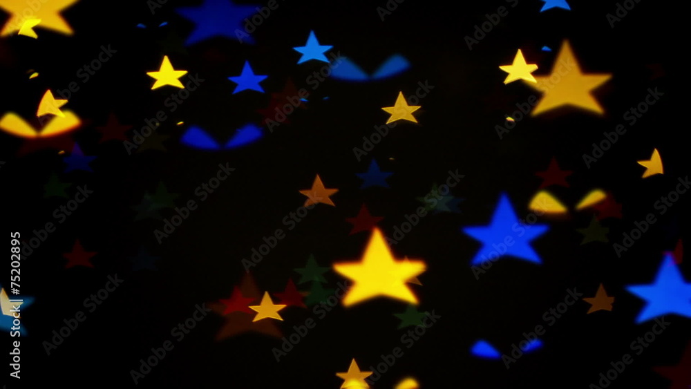 Colorful defocused blinking star shaped festive lights Colorful defocused blinking star shaped festive lights