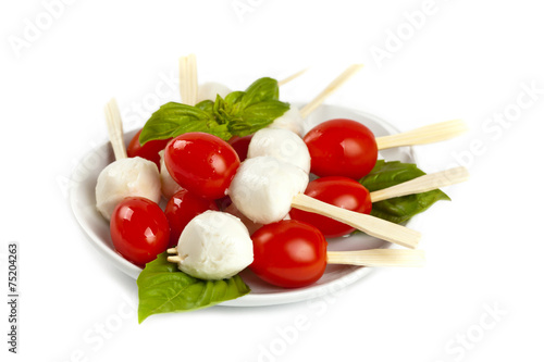 Salad on a sticks with mozzarella, tomatoes and basil