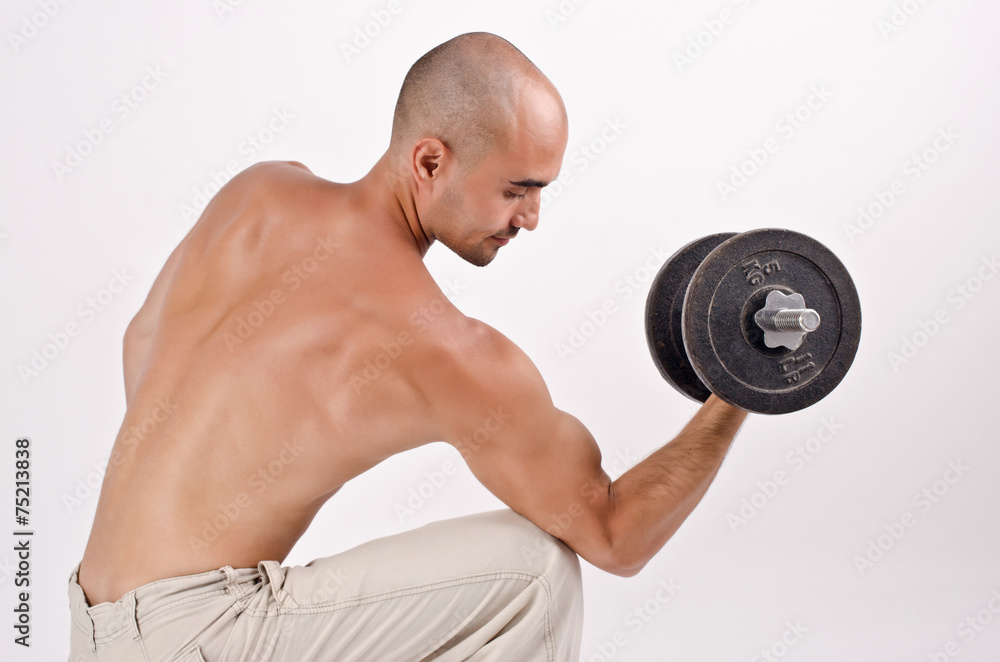 Strong man lifting weights for the biceps. Bodybuilder training. Strong man lifting weights for the biceps. Bodybuilder training.