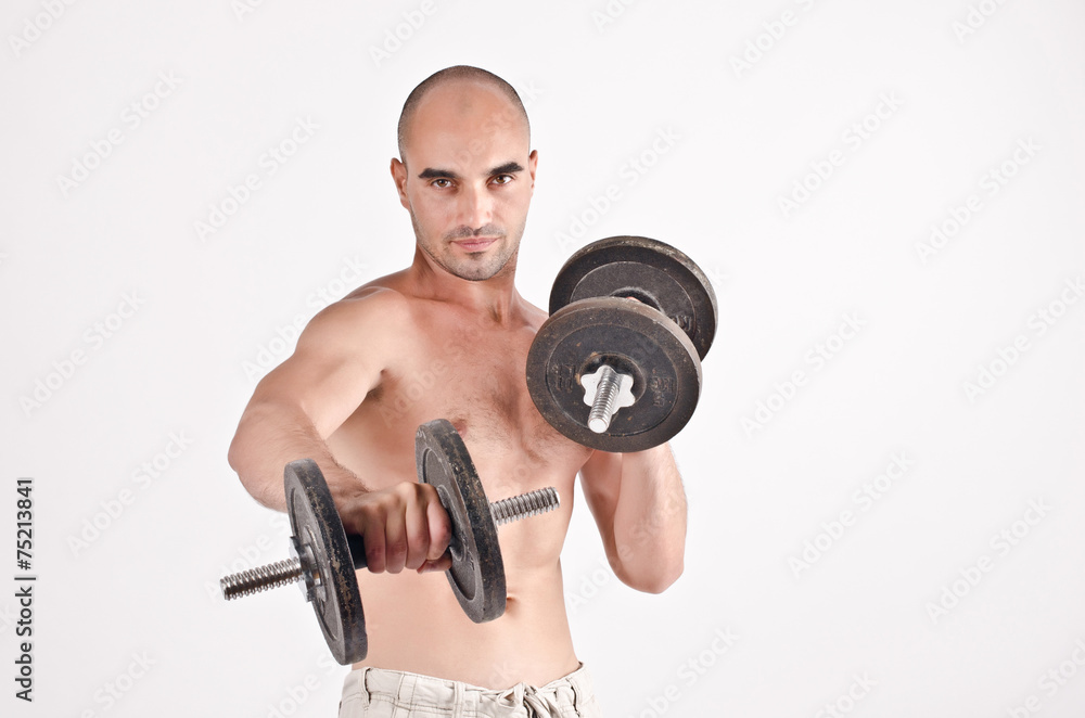 Strong man lifting weights.Bodybuilder training with dumbbells. Strong man lifting weights.Bodybuilder training with dumbbells.